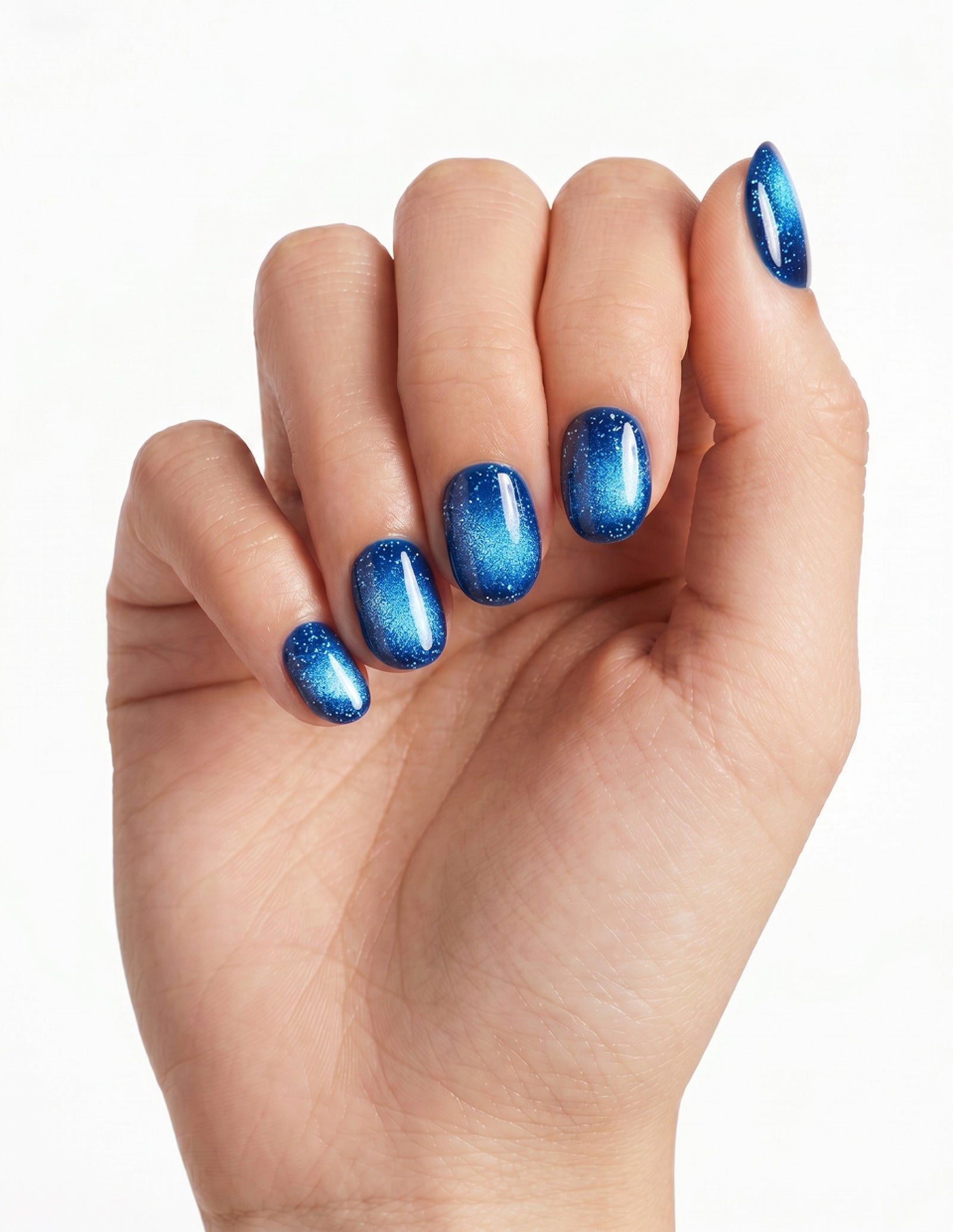 Cobalt press-on nails — Oval (extra-short), light-skin hand, fingers curled