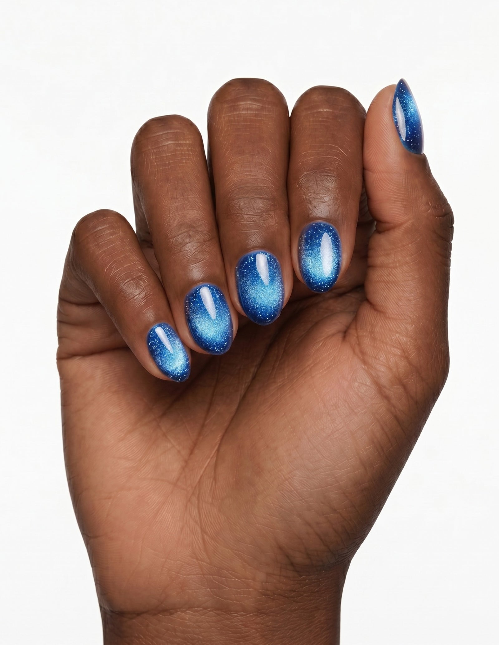 Cobalt press-on nails — Oval (extra-short), deep-skin hand, fingers curled