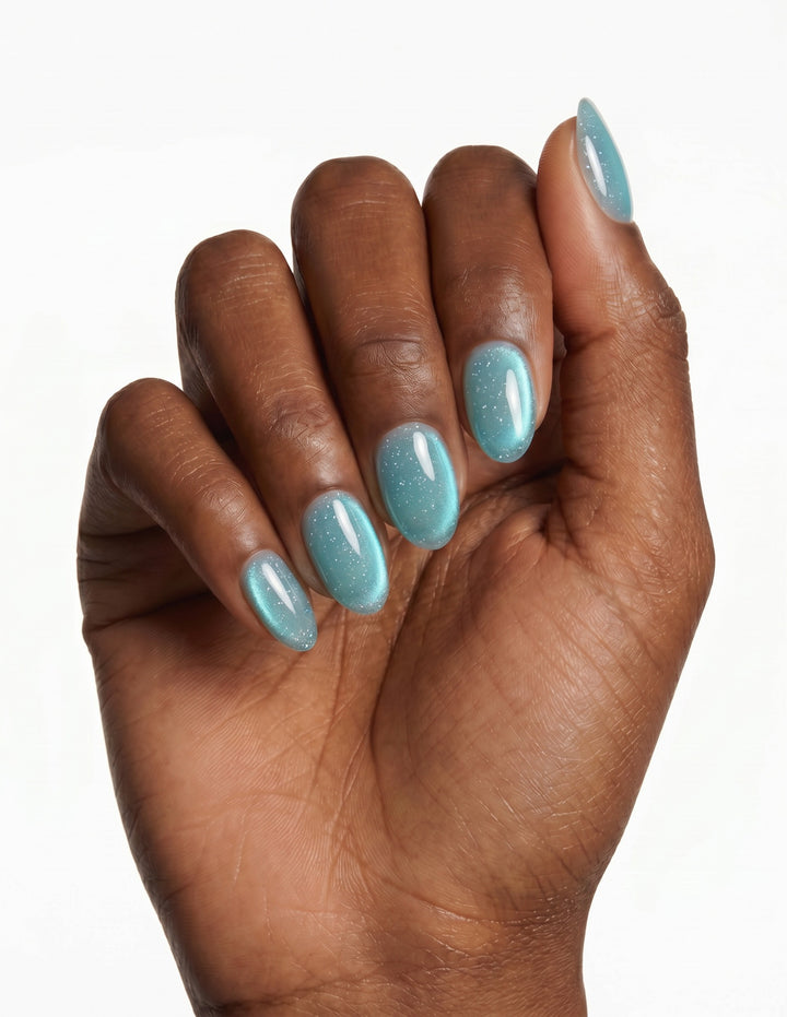 Aurora Lagoon press-on nails — Almond (extra-short), deep-skin hand, fingers curled