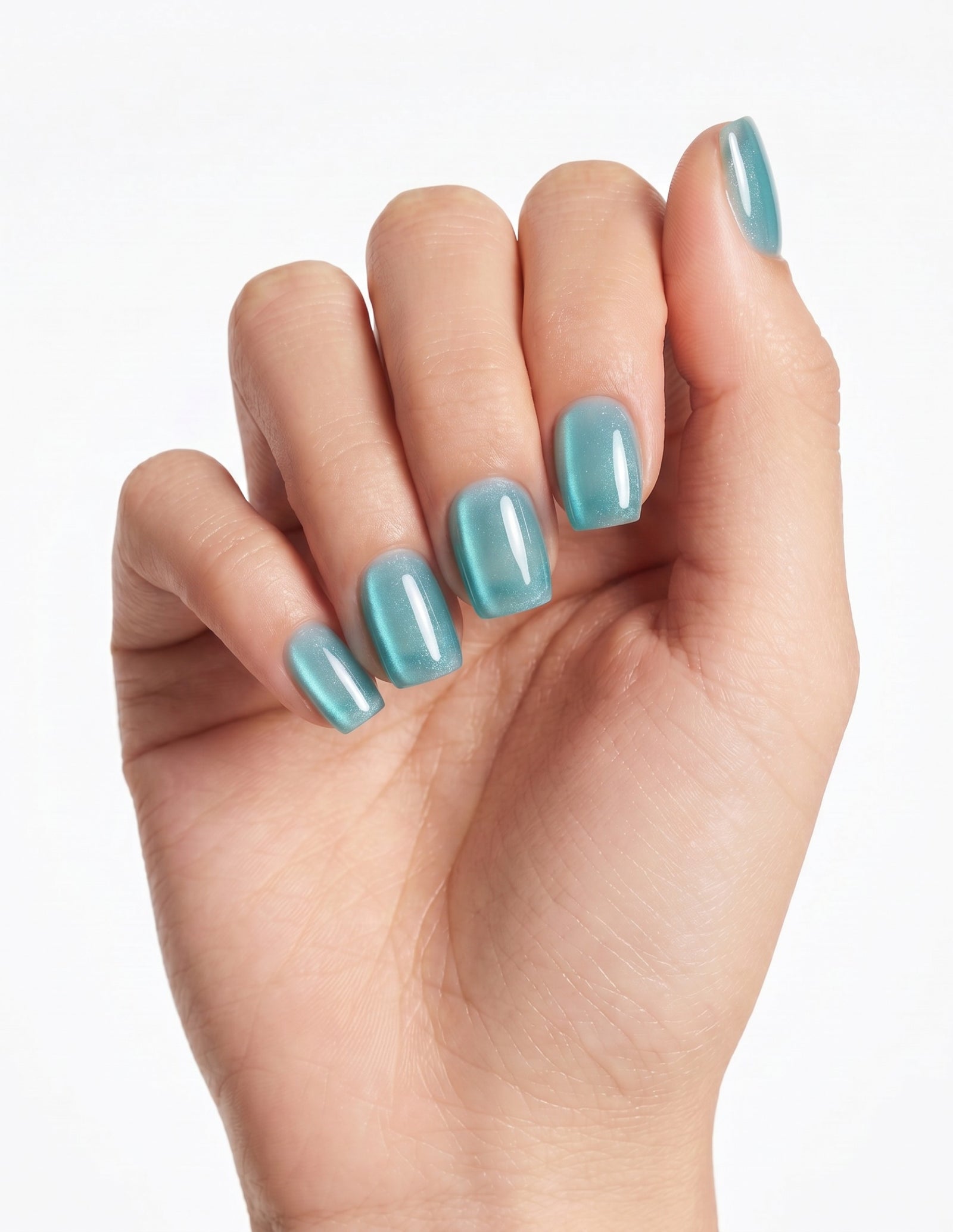 Aurora Lagoon press-on nails — Coffin (short), light-skin hand, fingers curled
