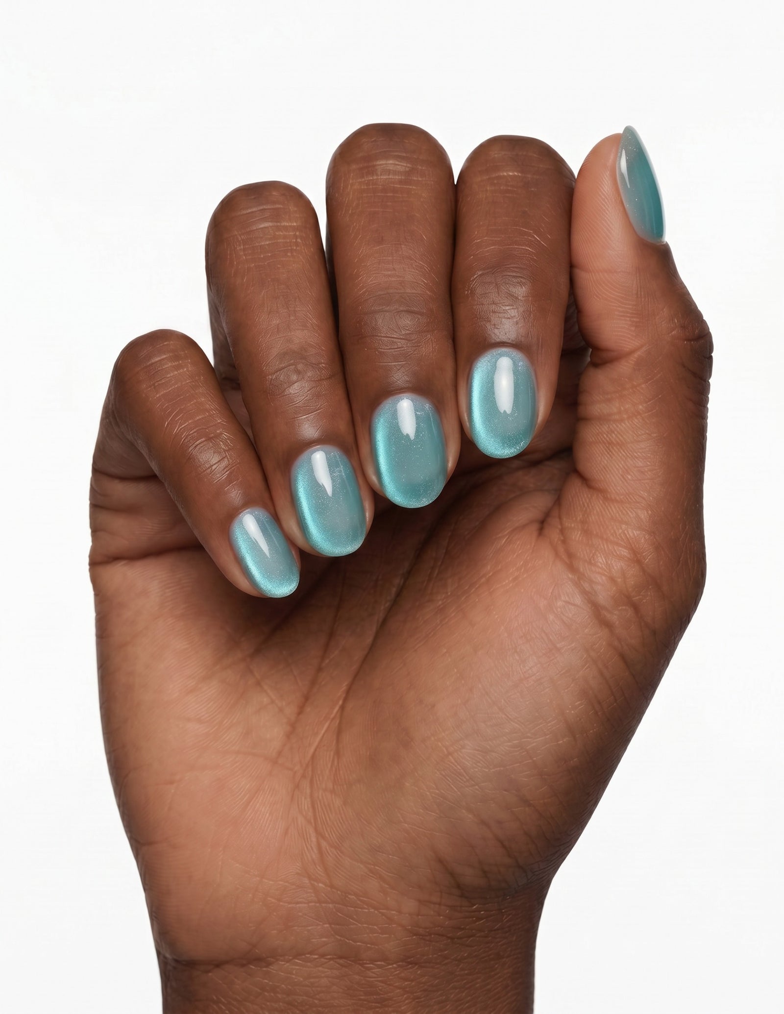 Aurora Lagoon press-on nails — Oval (extra-short), deep-skin hand, fingers curled