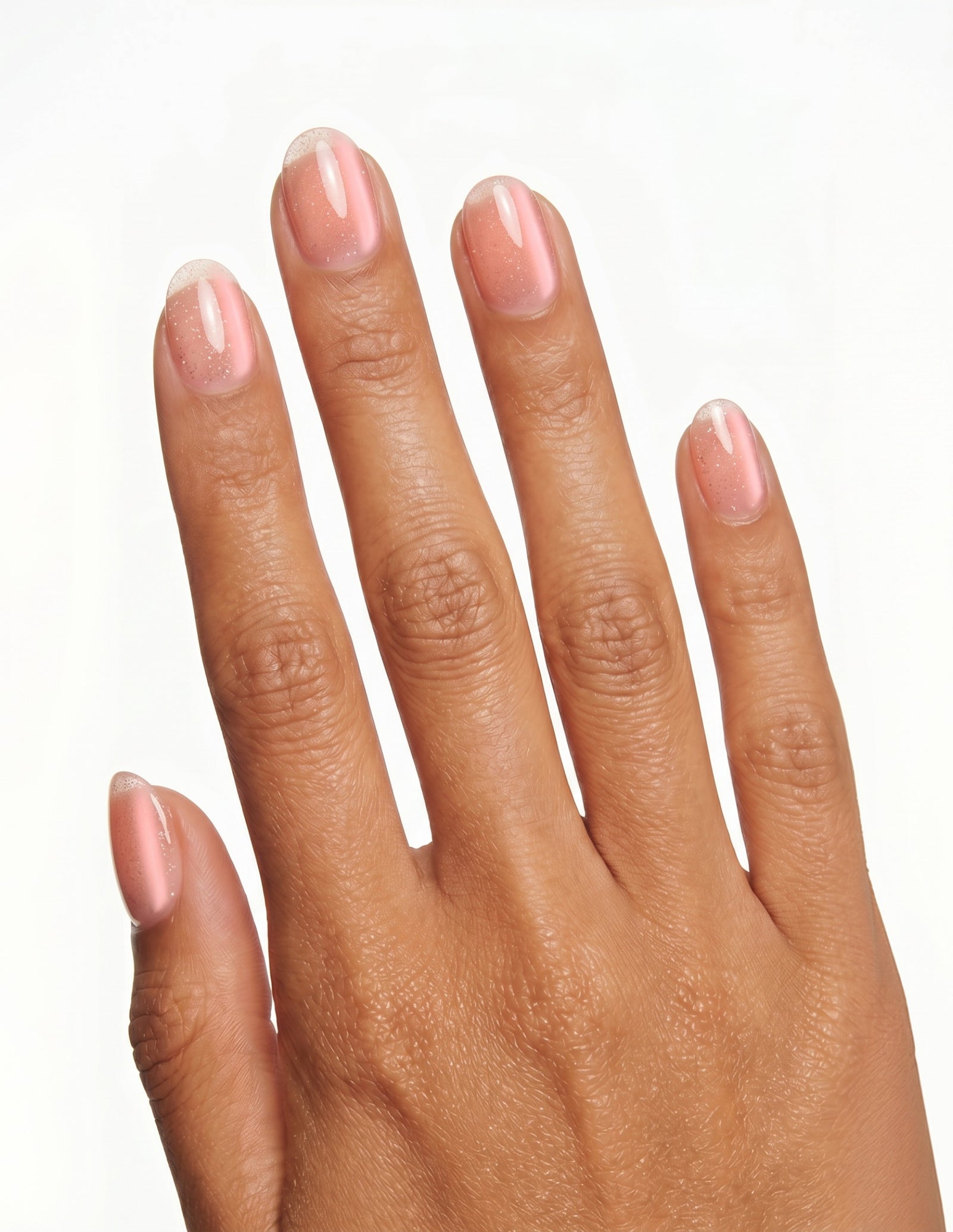 Aurora Blush press-on nails — Oval (extra-short), tan hand, back of hand