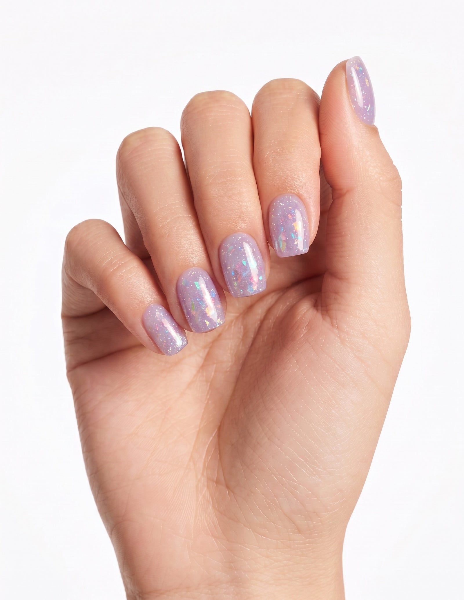 Aurora Lilac press-on nails — Coffin (short), light-skin hand, fingers curled