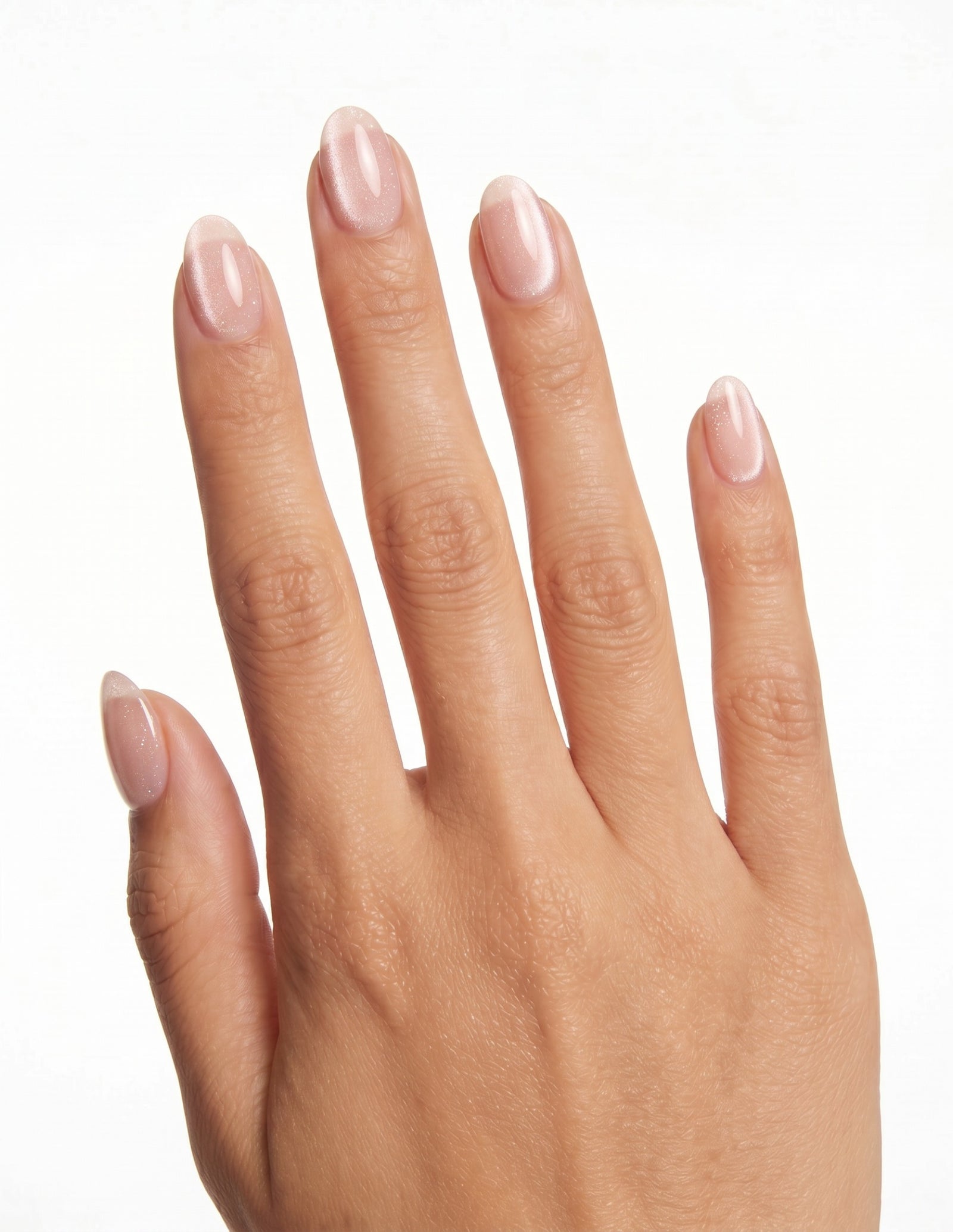 Aurora Champagne press-on nails — Almond (extra-short), tan hand, back of hand