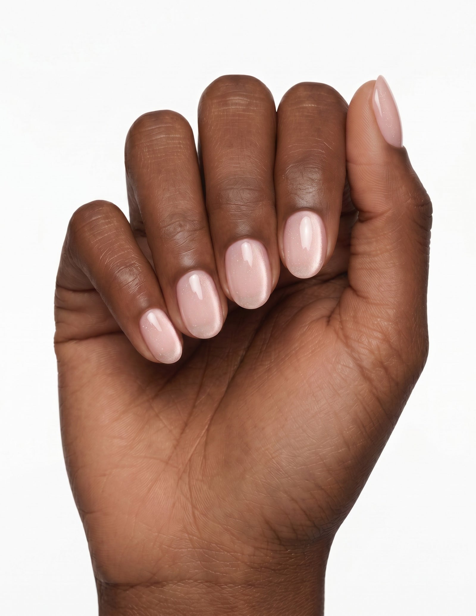 Aurora Champagne press-on nails — Oval (extra-short), deep-skin hand, fingers curled