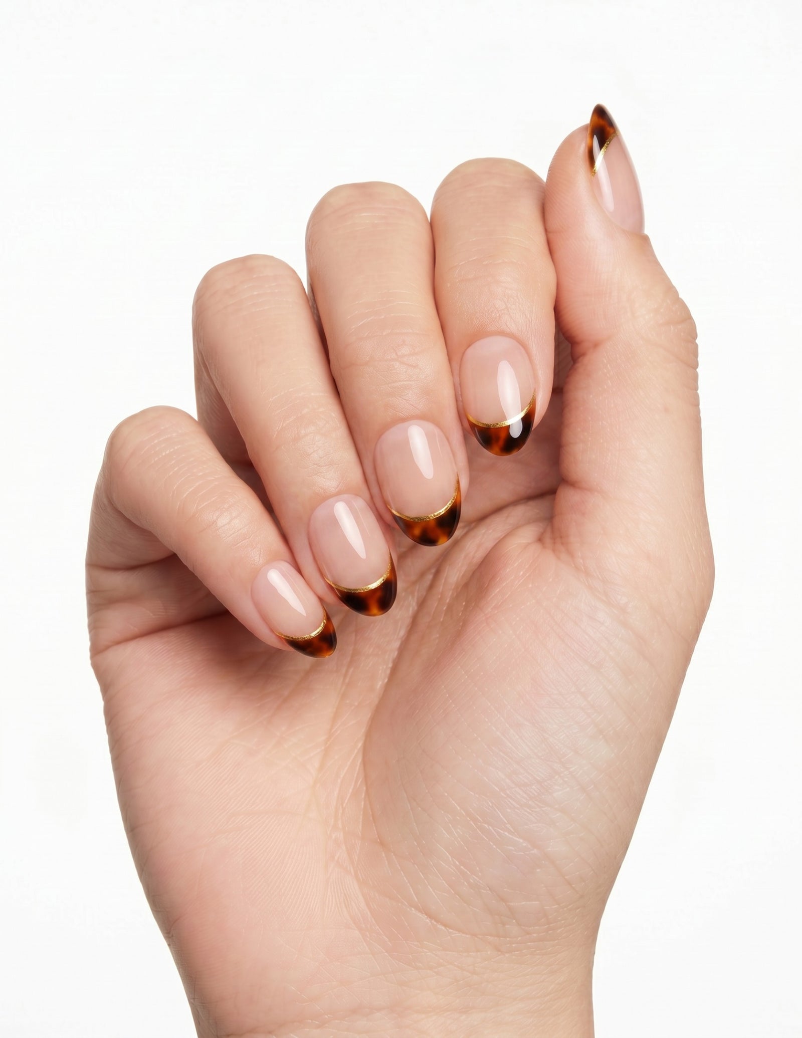 Tortoise Tips press-on nails — Almond (extra-short), light-skin hand, fingers curled