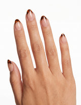 Tortoise Tips press-on nails — Almond (extra-short), tan hand, back of hand