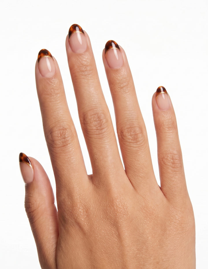 Tortoise Tips press-on nails — Almond (extra-short), tan hand, back of hand