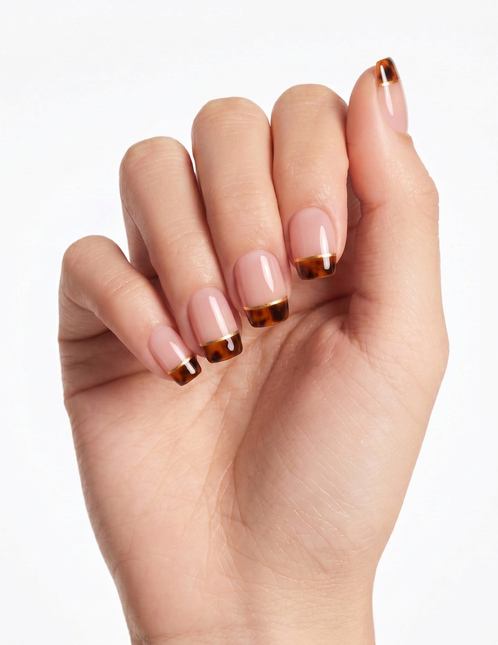 Tortoise Tips press-on nails — Coffin (short), light-skin hand, fingers curled