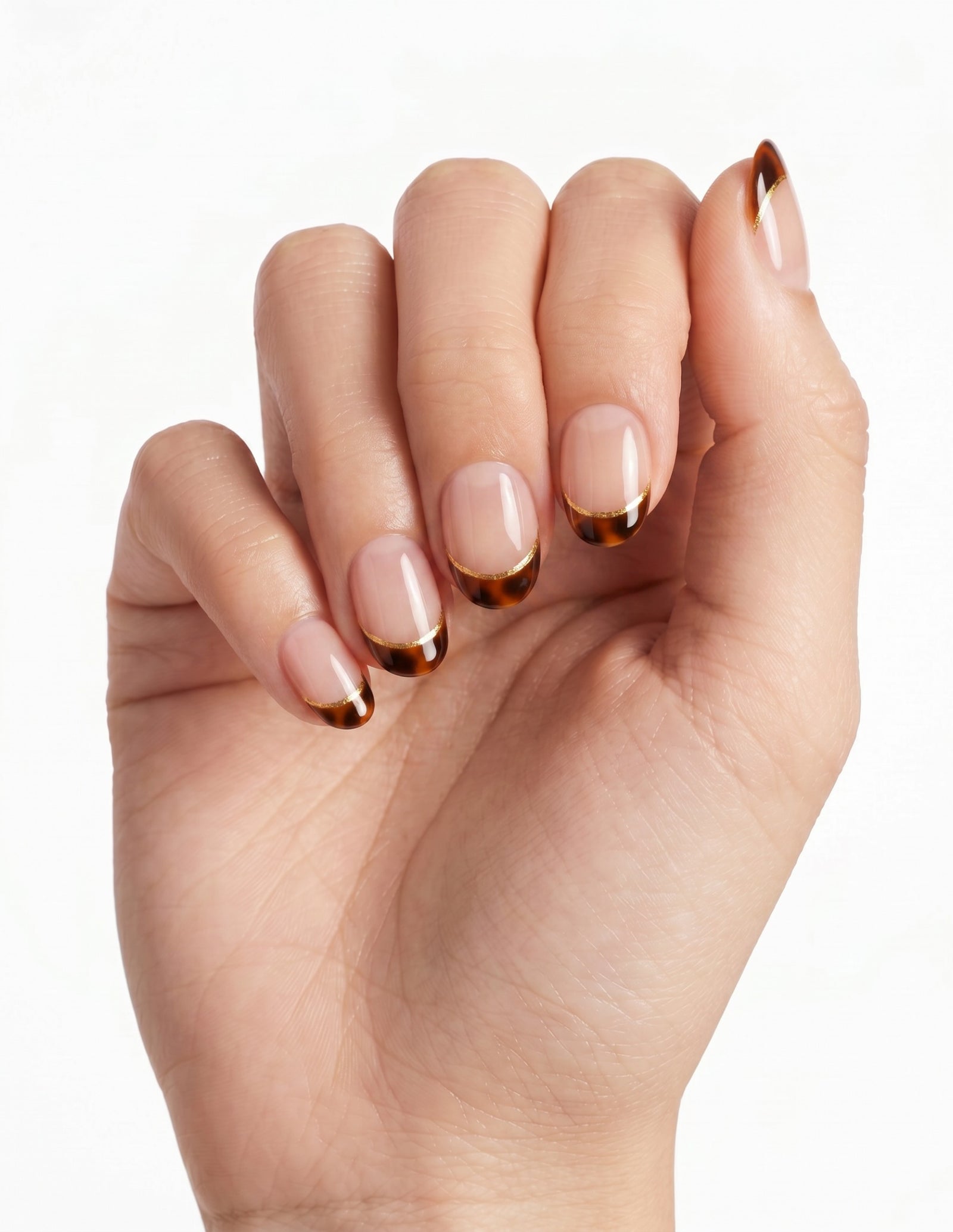 Tortoise Tips press-on nails — Oval (extra-short), light-skin hand, fingers curled