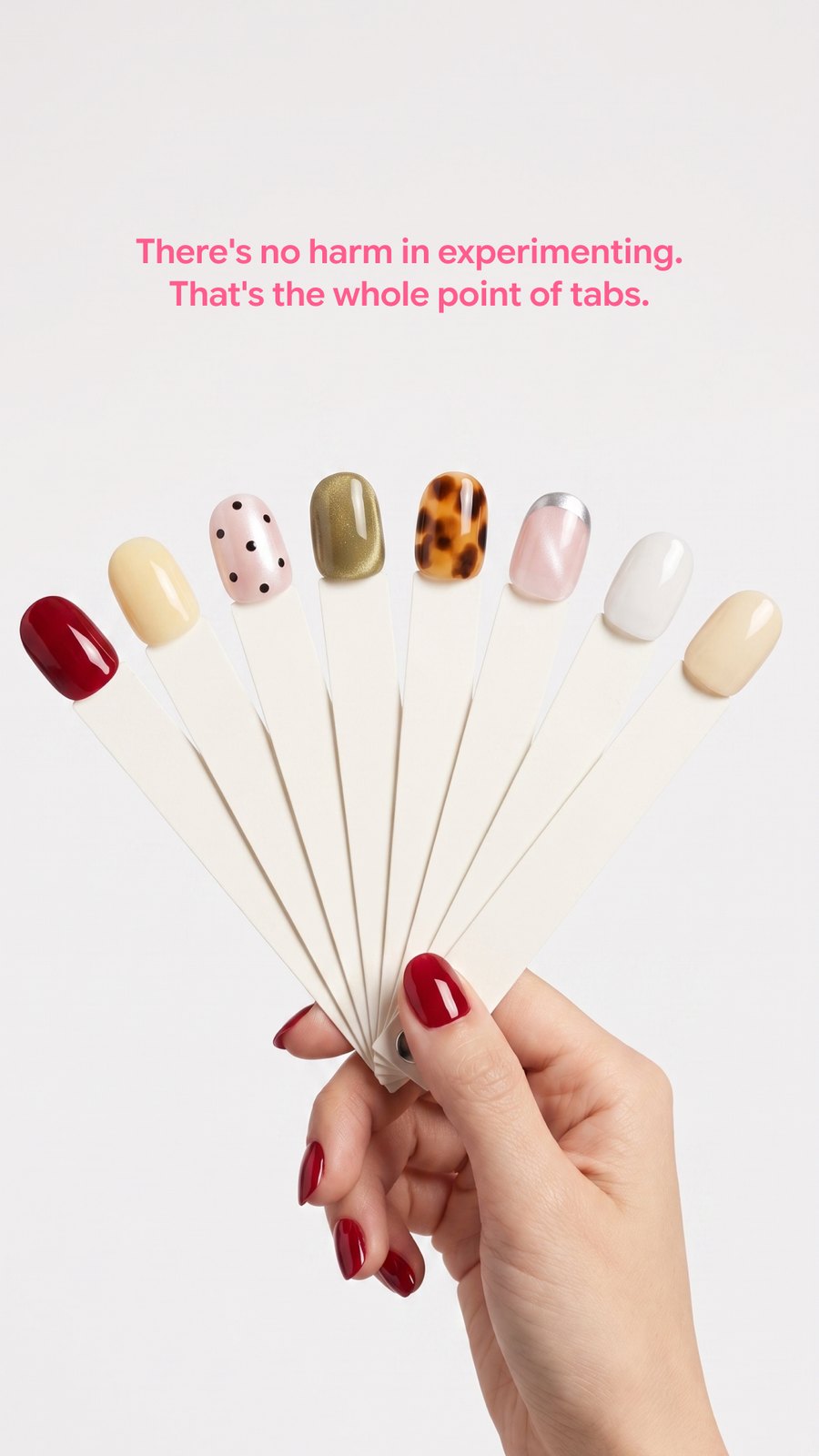 A hand holding a fan of press-on swatch sticks, captioned: there's no harm in experimenting, that's the whole point of tabs.